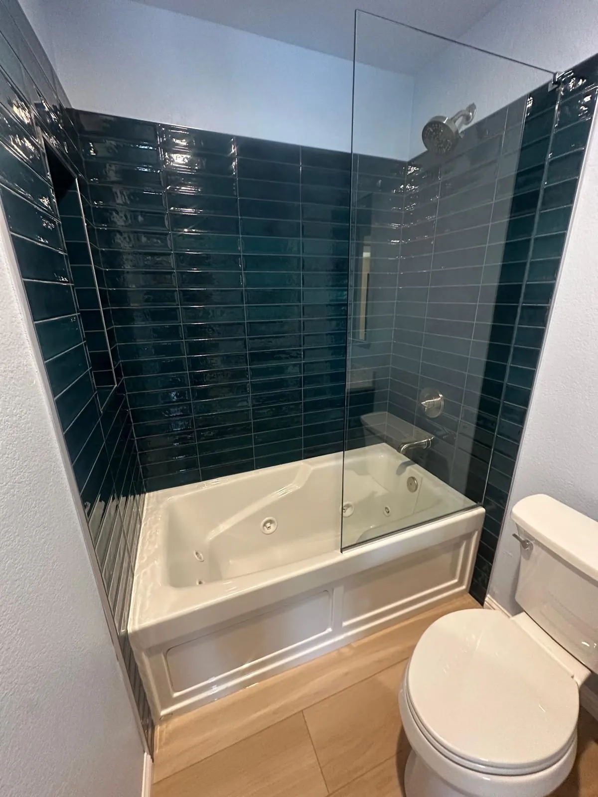 Phoenix, AZ bathroom remodel by RDC with a jetted tub and blue subway tile shower walls