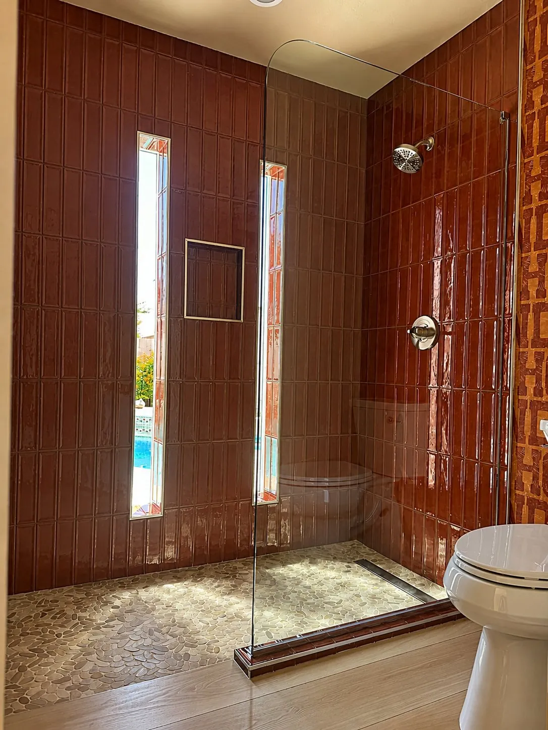 Walk-in shower in glossy terracotta subway tile, part of an RDC bathroom remodel in Phoenix, AZ