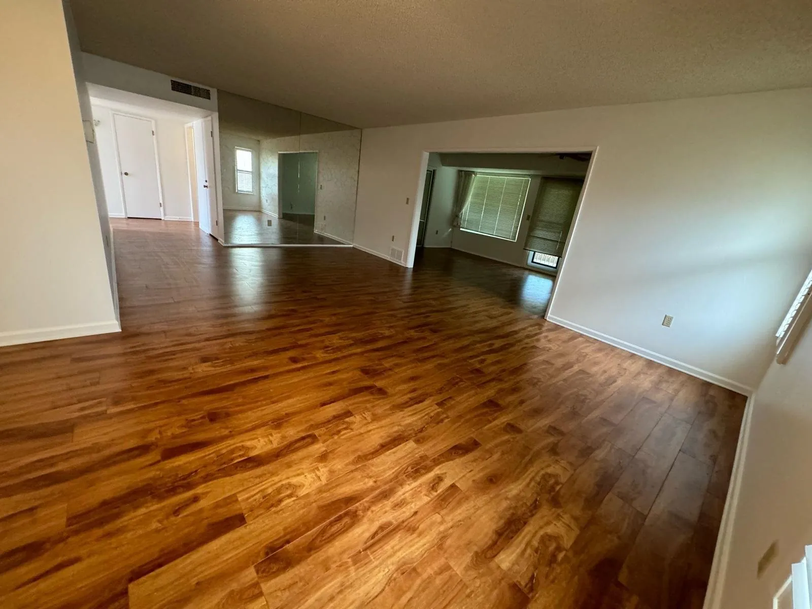 Sun City, AZ living room with warm wood-look laminate flooring from an RDC flooring project