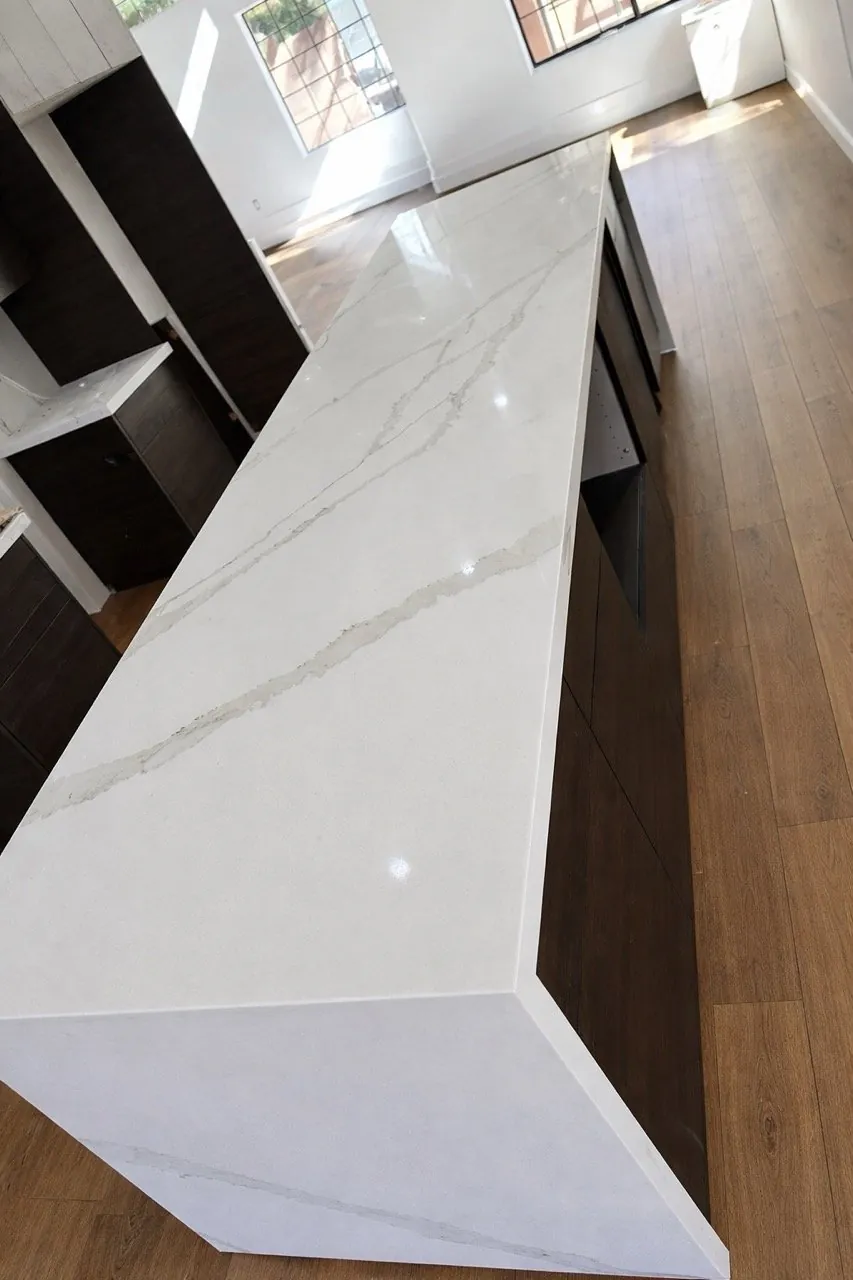 Scottsdale, AZ kitchen island topped with a white quartz waterfall countertop, an RDC countertop job